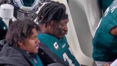 AJ Brown reading on the Eagles bench