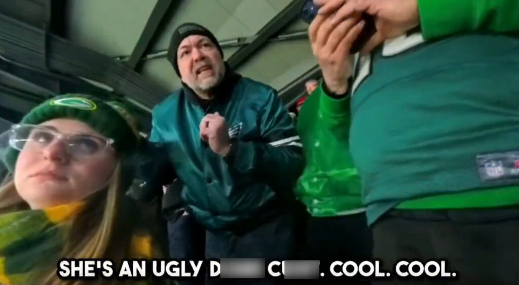 Eagles fan and Packers fan in stands