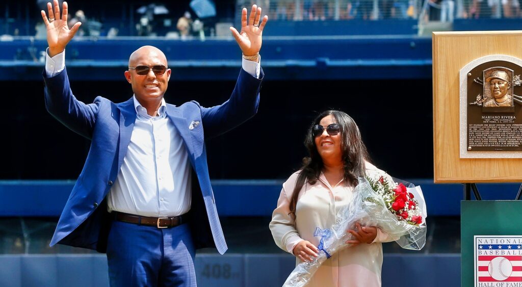 Mariano Rivera standing next to his wife