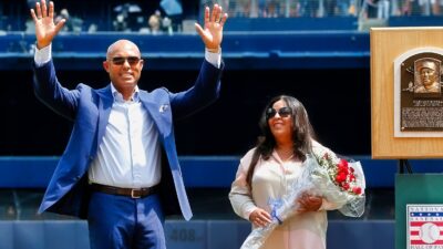 Mariano Rivera standing next to his wife