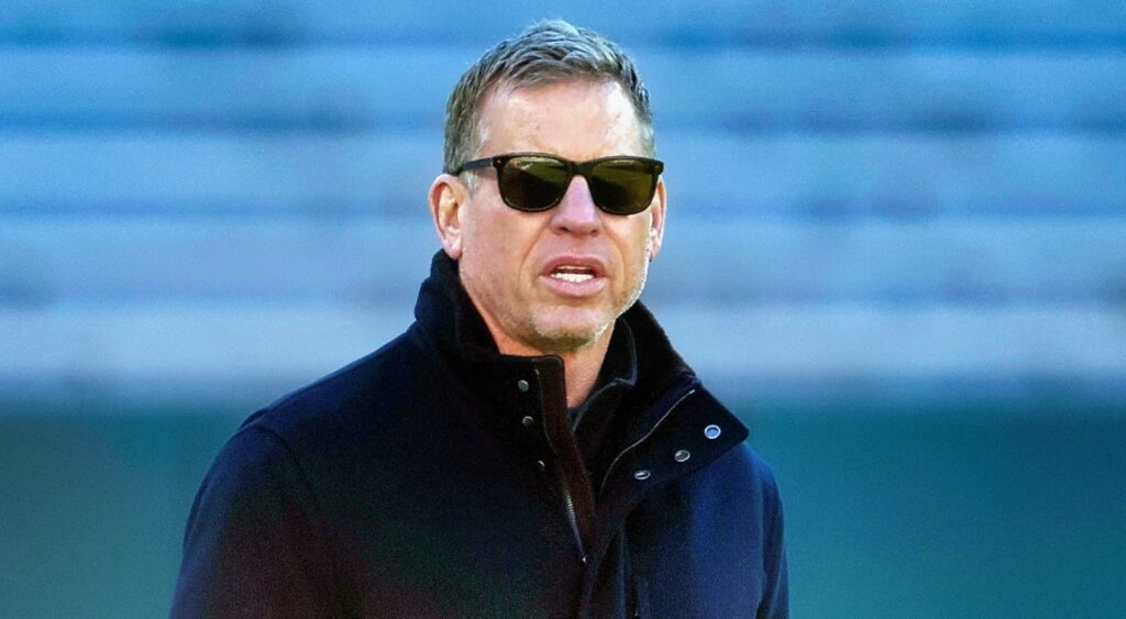 Troy Aikman looking on.