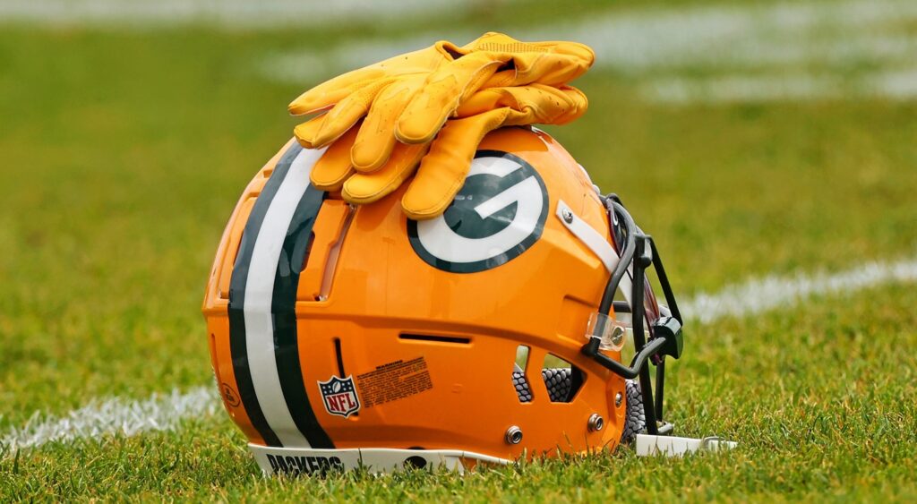 Green Bay Packers helmet shown on field. 