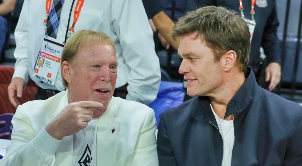 Mark Davis speaking to Tom Brady during game.