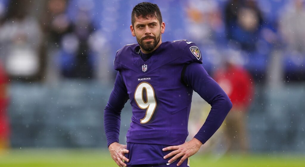 Justin Tucker with his hands at his side