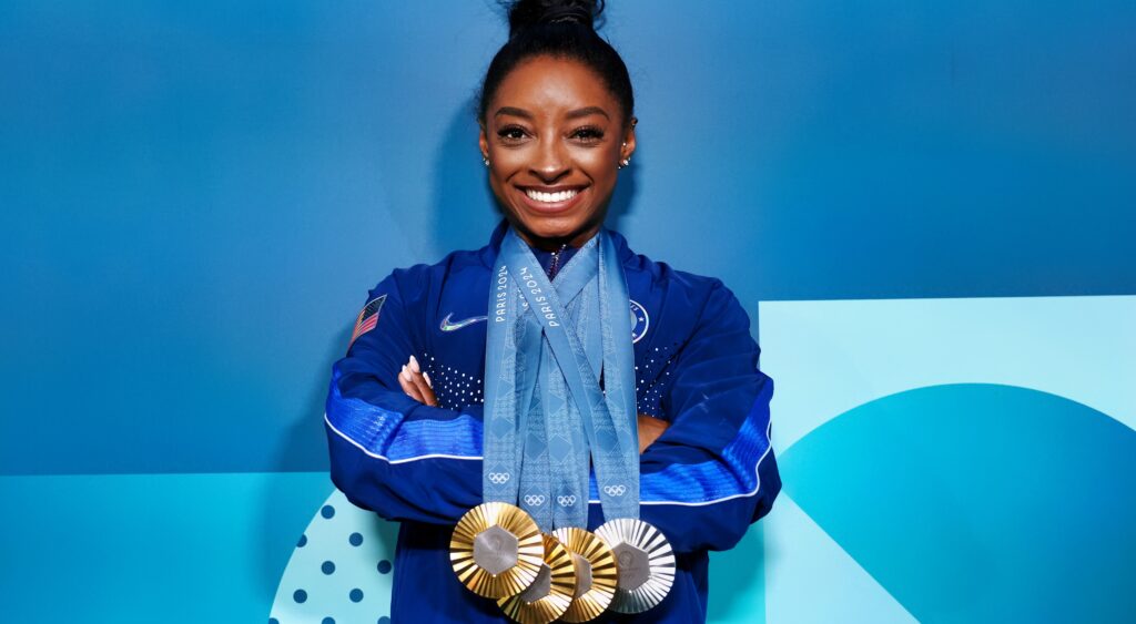 Simone Biles poses with her Olympic medals.