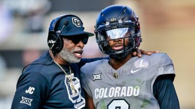 Shedeur Sanders and Deion Sanders on field