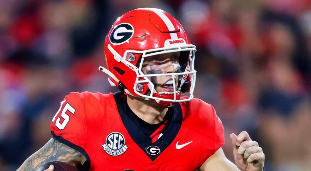 Carson Beck of Georgia Bulldogs running with football.