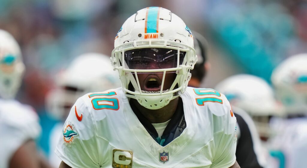 Tyreek Hill of Miami Dolphins looking on.