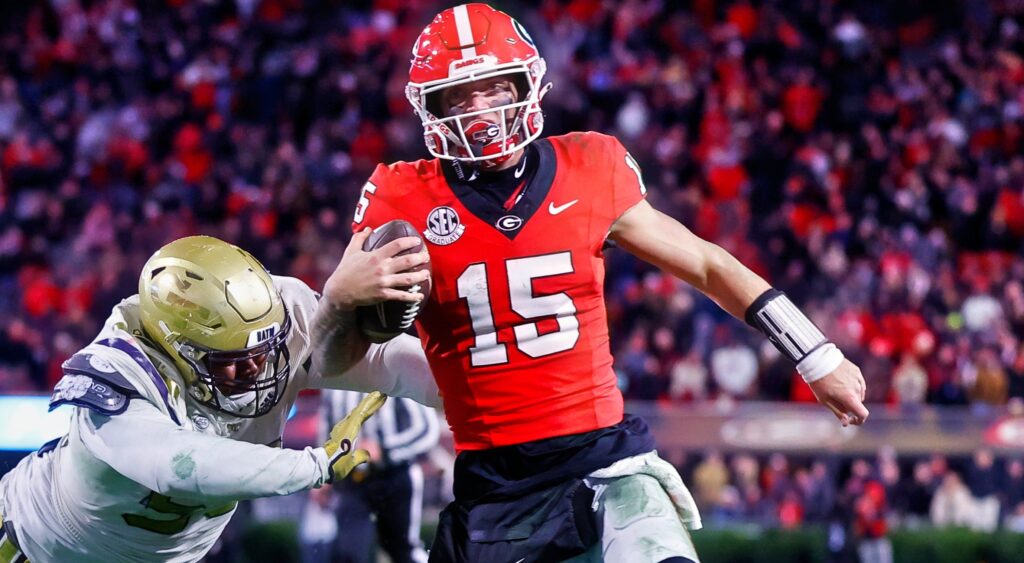 Carson Beck running with football