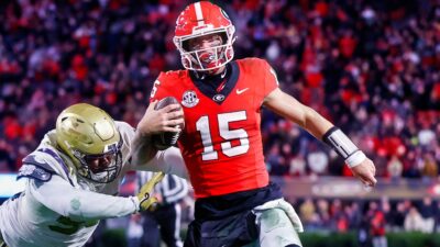 Carson Beck running with football