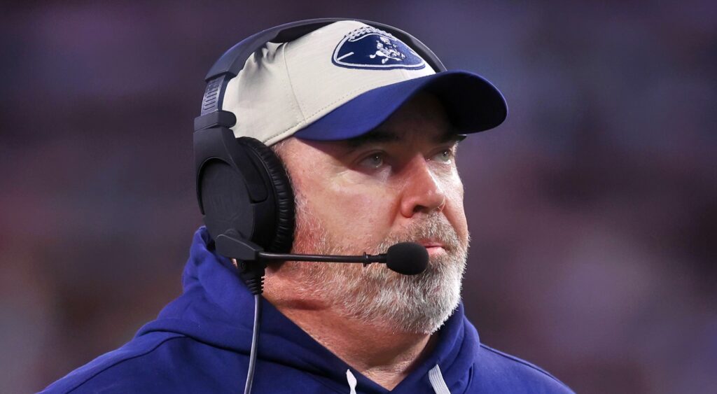 Mike McCarthy of Dallas Cowboys looking on.