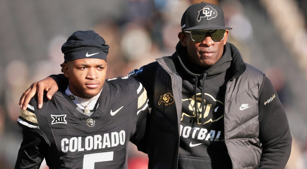 Dion Sanders holding Jimmy Horn Jr.