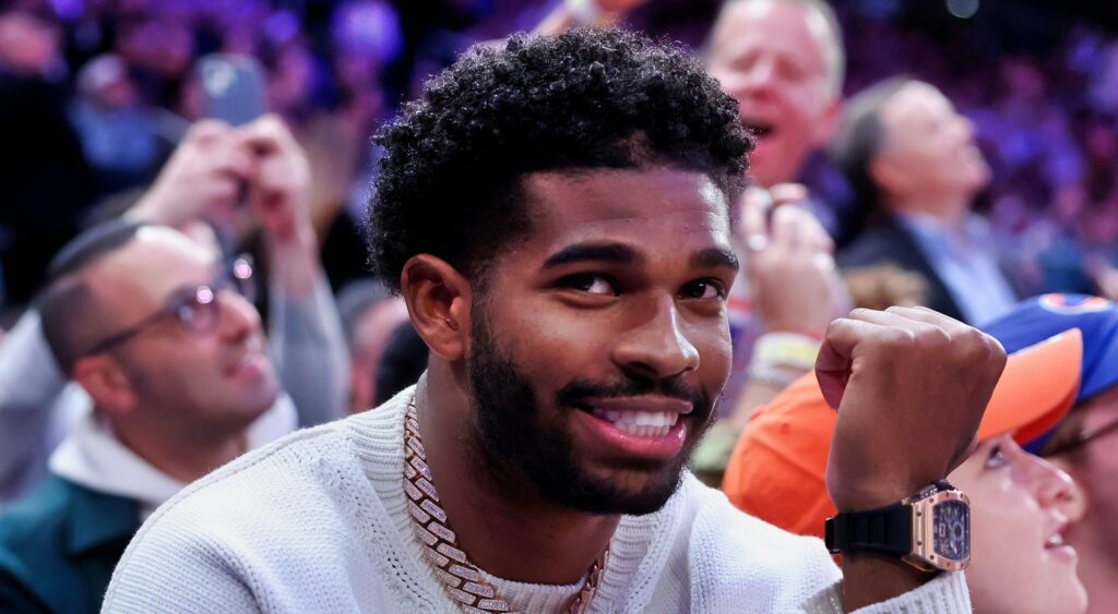 Shedeur Sanders sitting courtside