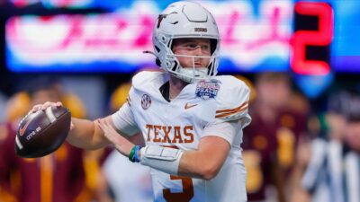 Quinn Ewers throwing football