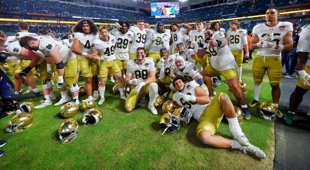 Notre Dame players taking picture on field