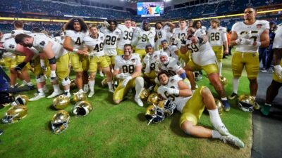 Notre Dame players taking picture on field