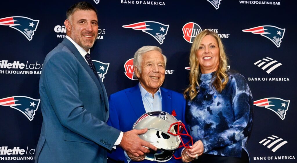 Mike Vrabel. Robert Kraft and Jen Vrabel posing with New England Patriots helmet.