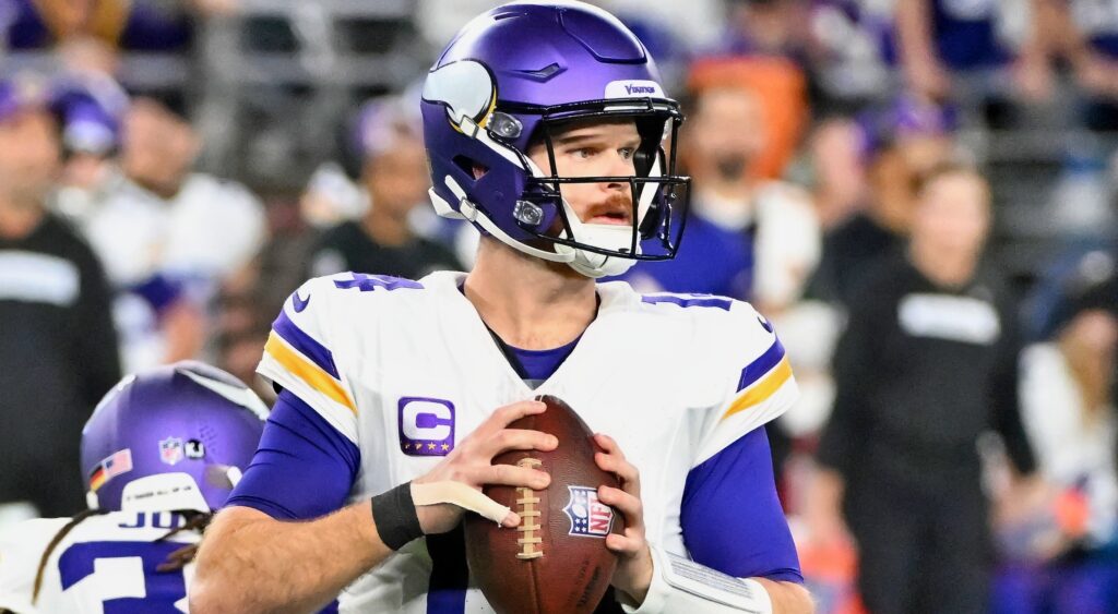 Sam Darnold holding football