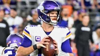 Sam Darnold holding football