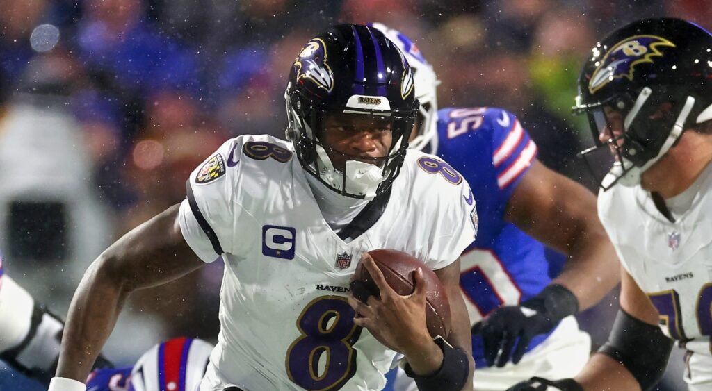 Lamar Jackson of Baltimore Ravens running with football.