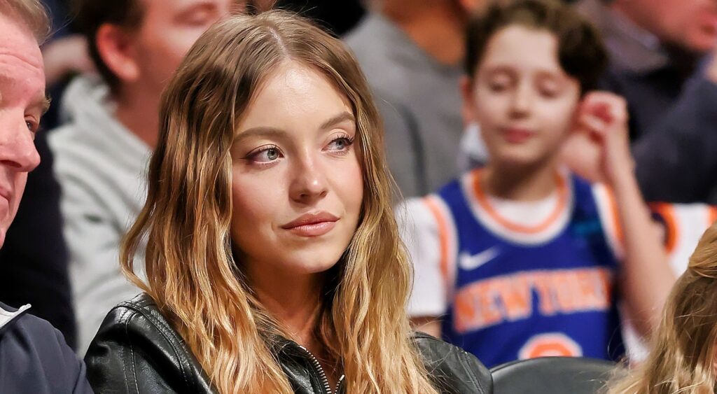 Sydney Sweeney sitting courtside