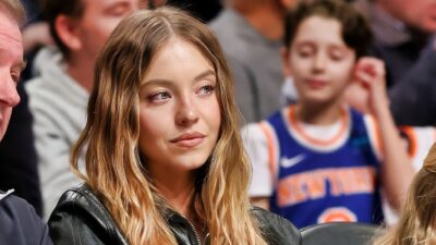 Sydney Sweeney sitting courtside