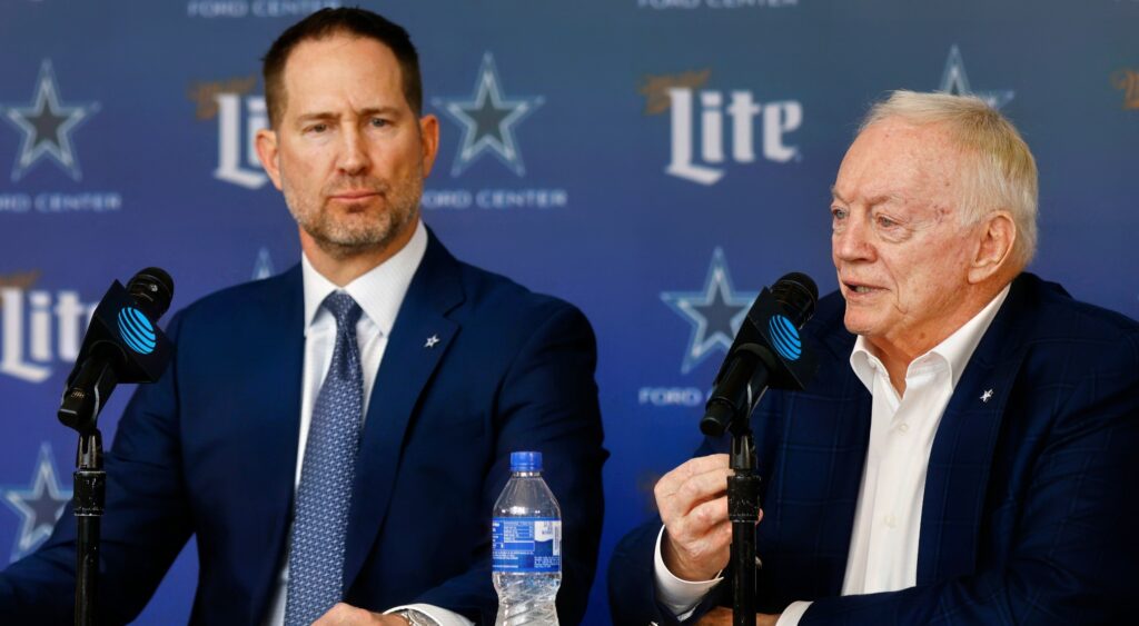 Brian Schottenheimer sitting next to Jerry Jones