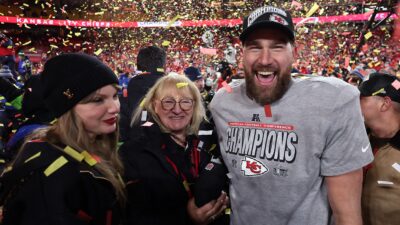 Travis Kelce, Dona Kelce, and Taylor Swift on field