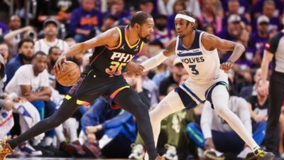 Kevin Durant of the Phoenix Suns handles the ball against Jaden McDaniels of the Minnesota Timberwolves