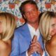 Lane Kiffin standing between two ladies