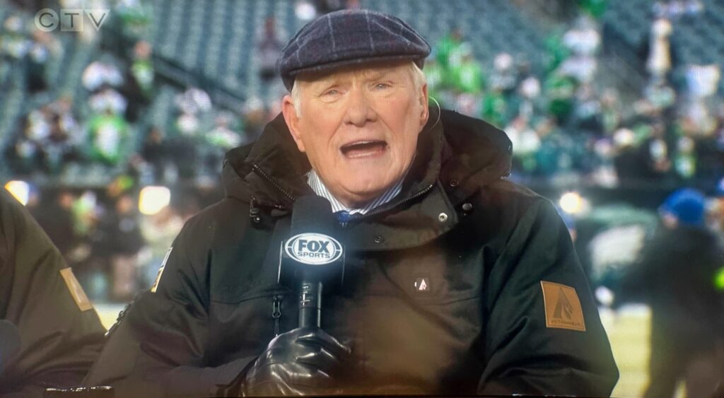 Terry Bradshaw holding mic