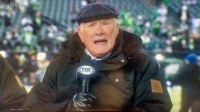 Terry Bradshaw holding mic