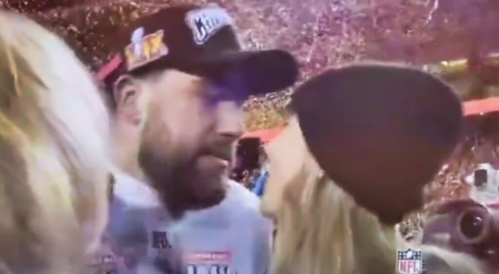 Travis Kelce and Taylor Swift looking at each other before a kiss