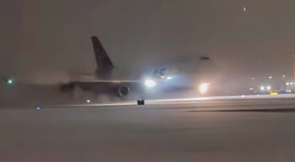 Denver Broncos' team plane landing in snow at At Buffalo Niagara International Airport.