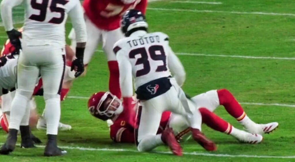 Patrick Mahomes talking to Henry To'oTo'o after being tackled.