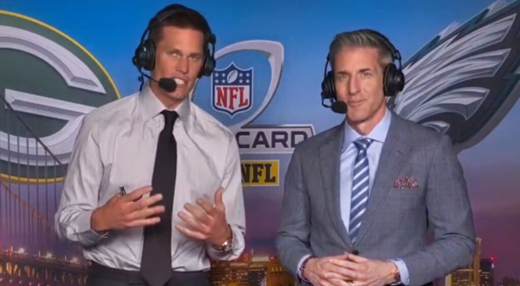 Tom Brady and Kevin Burkhardt speaking in broadcast booth.