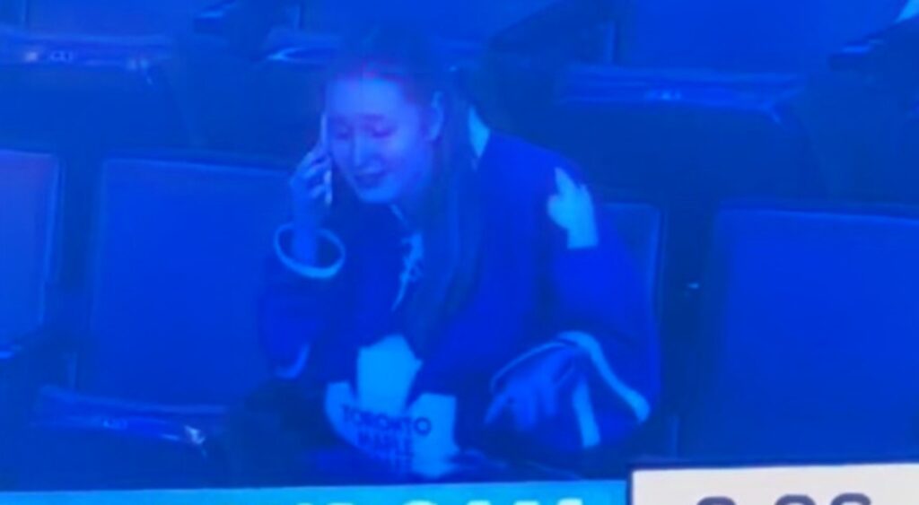 Toronto Maple Leafs fan speaking on phone.