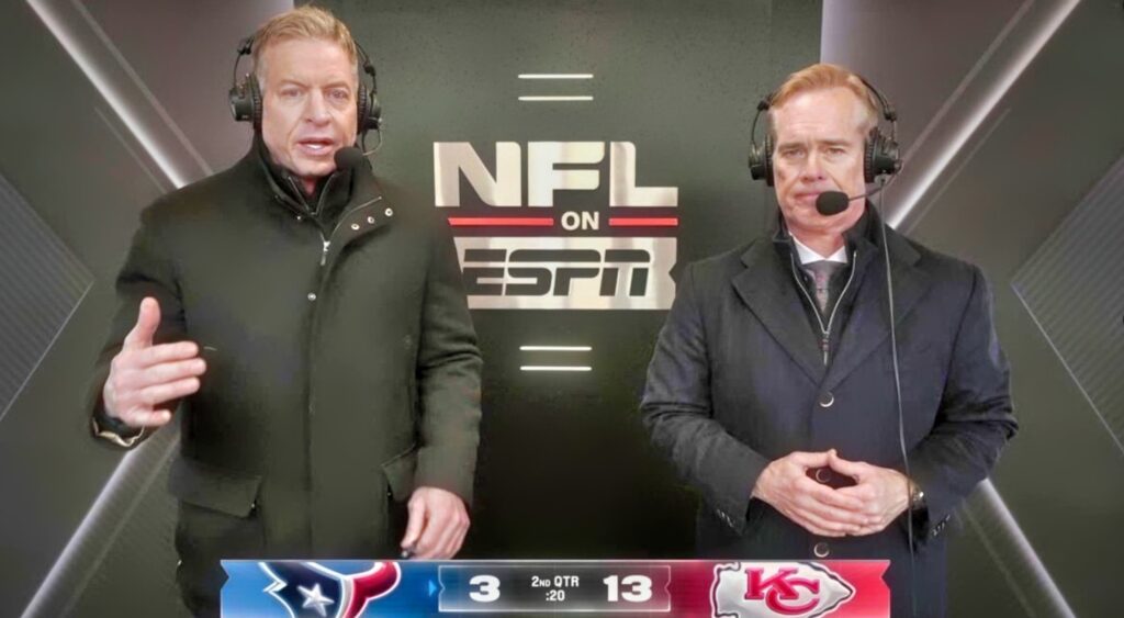 Troy Aikman and Joe Buck speaking in broadcast booth.