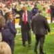 Chris Jones and Donald Trump on field