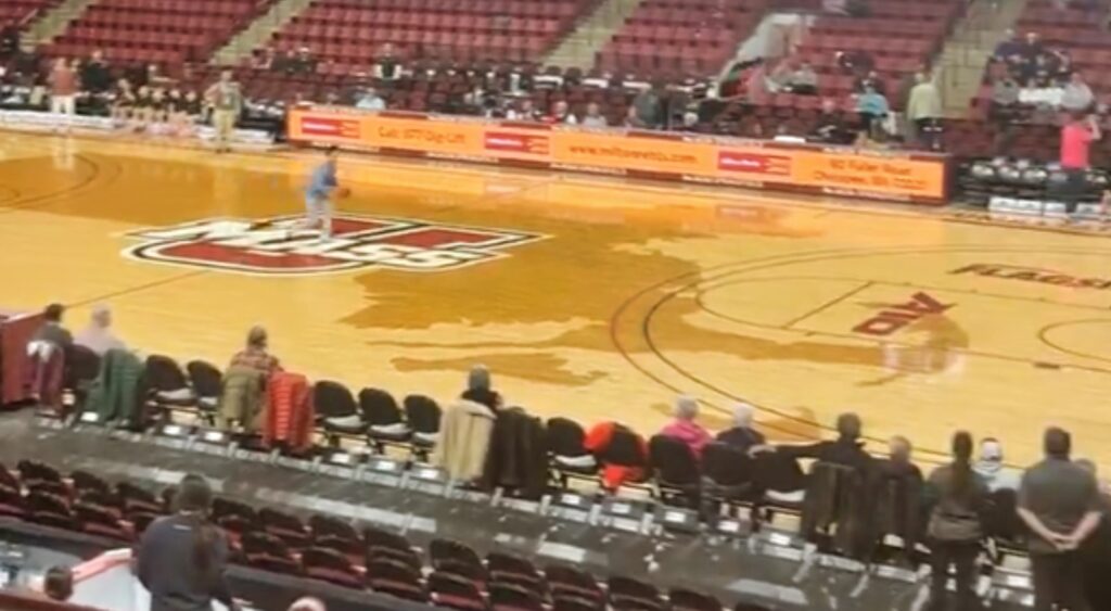 fan shooting from halfcourt at women's college basketball game