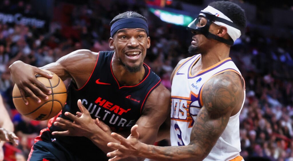 Jimmy Butler trying to dribble past Bradley Beal.