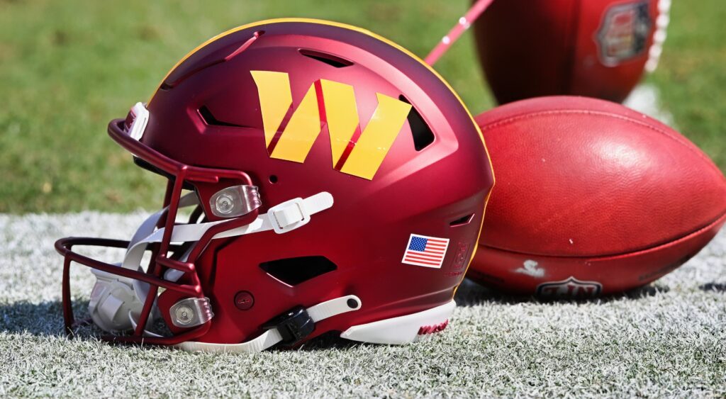 Washington Commanders helmet and football on field