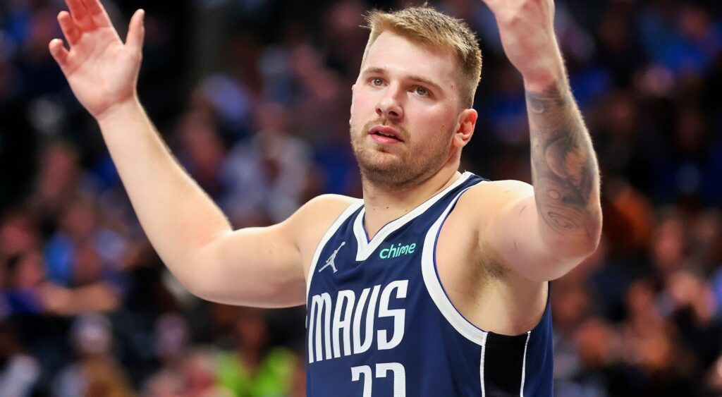 Luka Doncic with his hands in the air