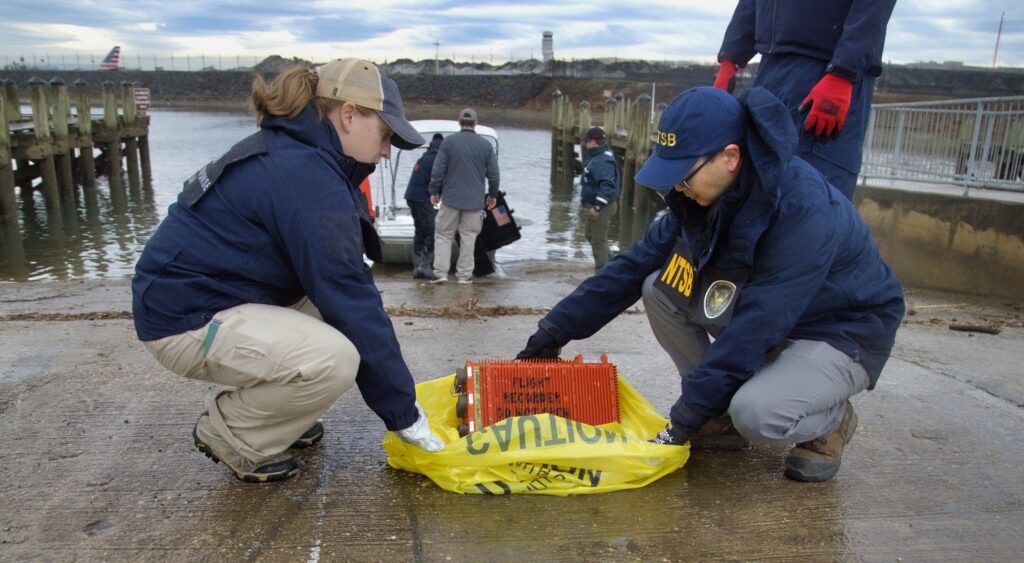 NTSB Investigators with flight recorder from American Airlines flight 5342.