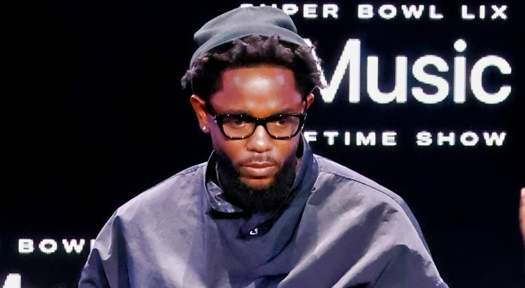 Kendrick Lamar in black outfit and glasses