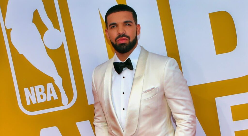 Drake posing in white suit