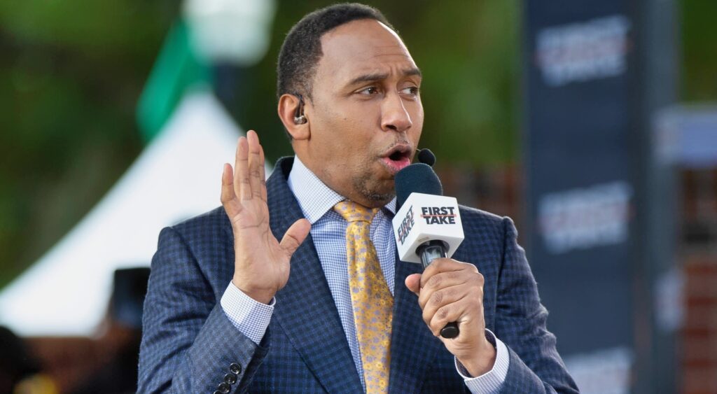 Stephen A Smith speaking into a microhone