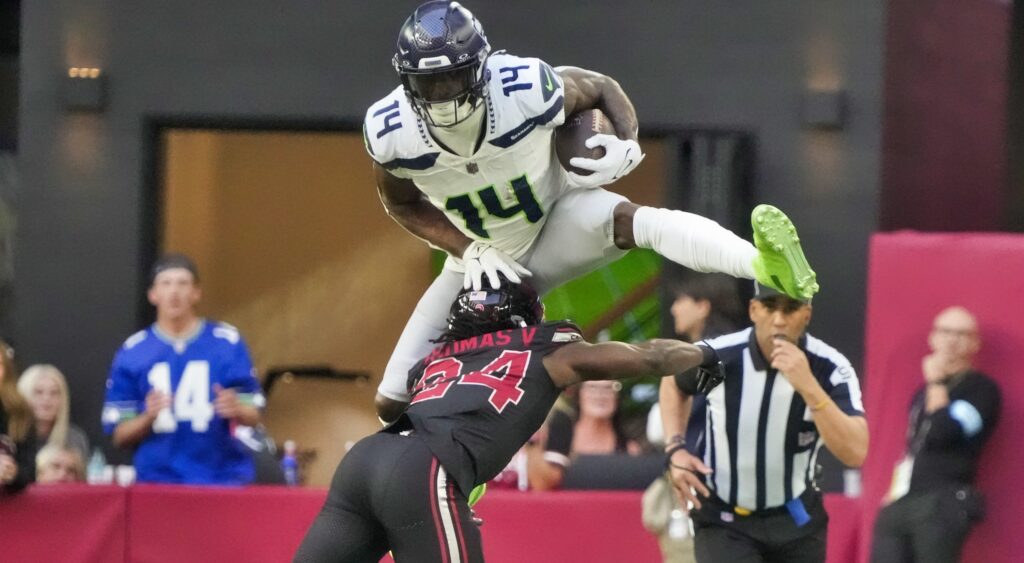 DK Metcalf jumping over defender