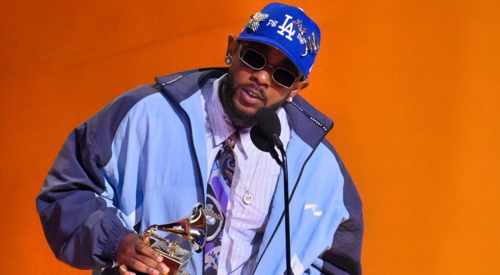 Kendrick Lamar holding award