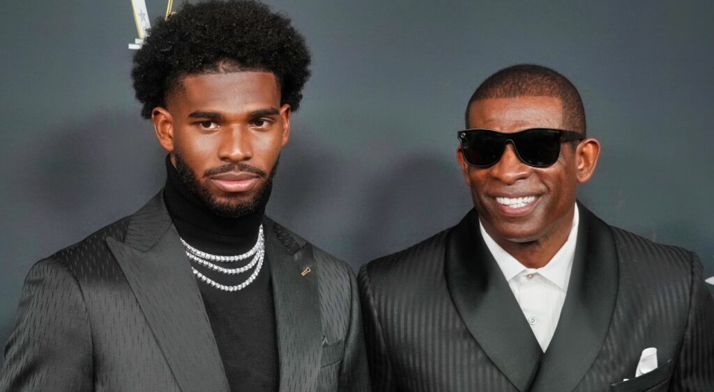 Shedeur Sanders standing next to his facther Deion Sanders